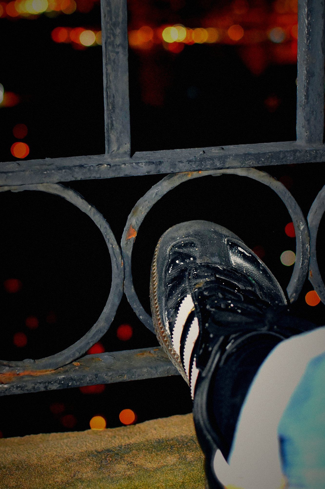 4:47 AM. One shoe on a railing. The city under it. Nobody claimed the shoe.
