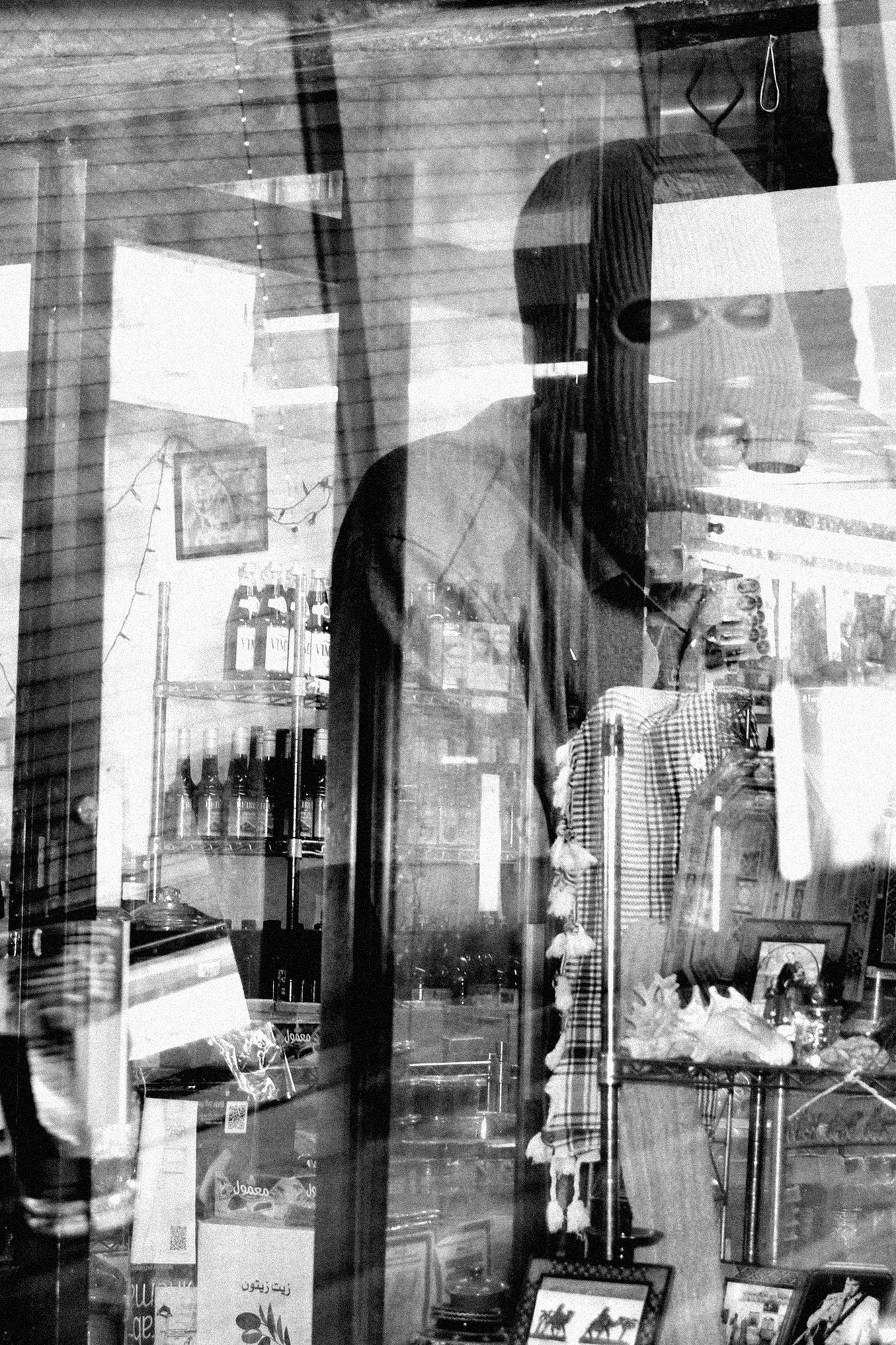 The mask, through the window of a shop that sells ouds.